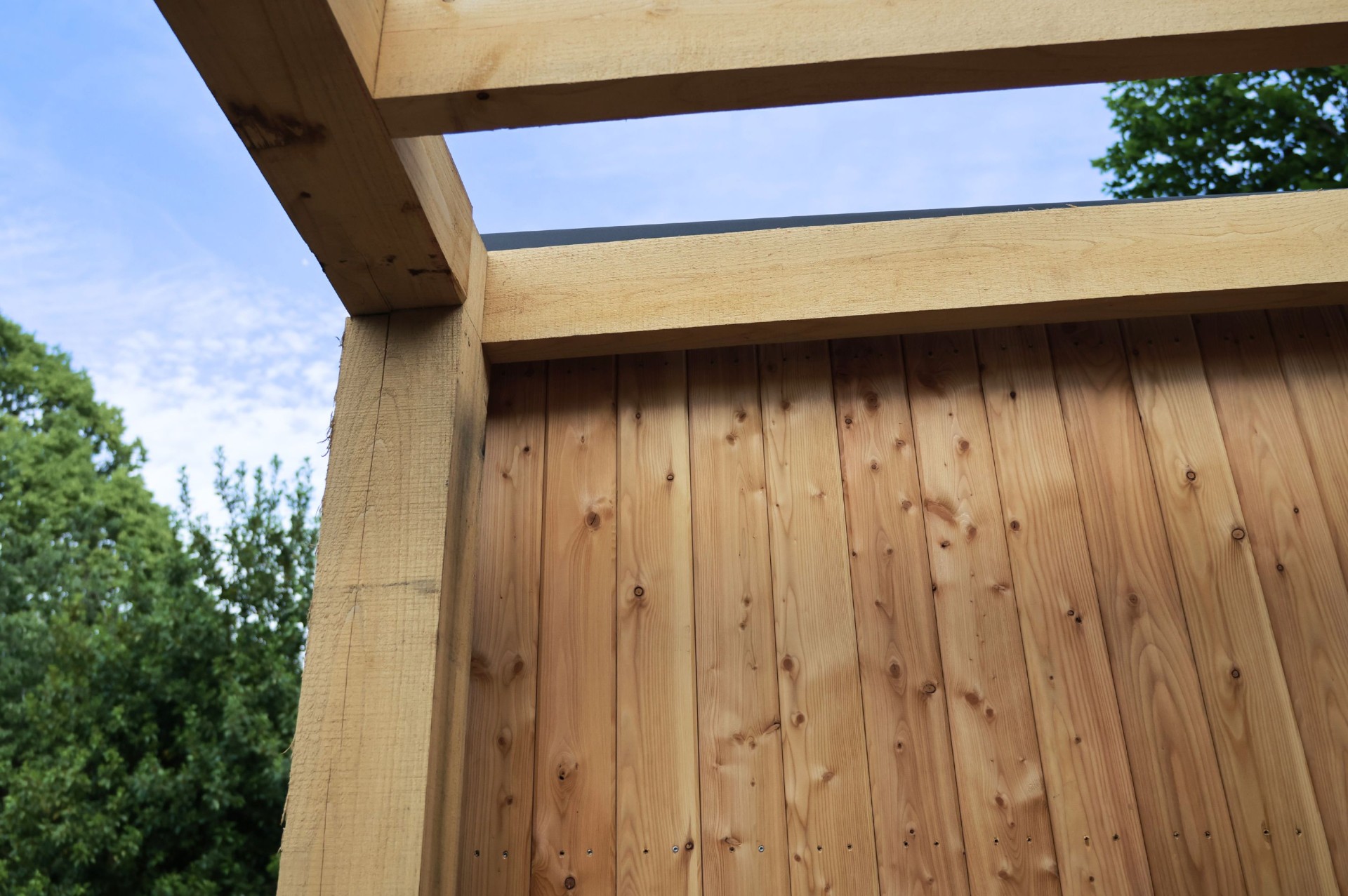 Sweet chestnut side pergola structure detail against sky