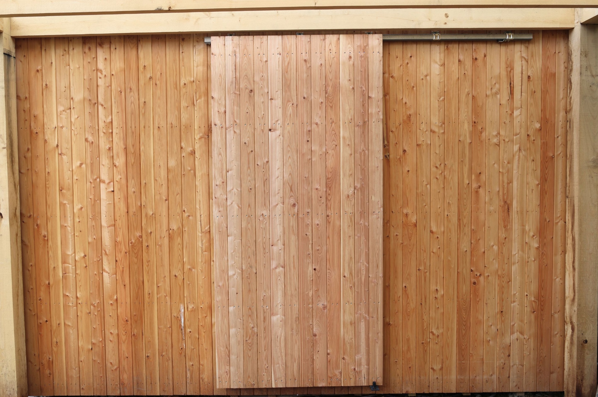 External sliding barn-style timber door on track