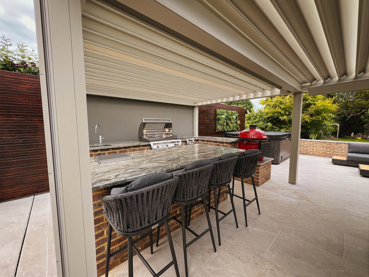 Marble-topped bar with stools beneath the louvred pergola overlooking the garden