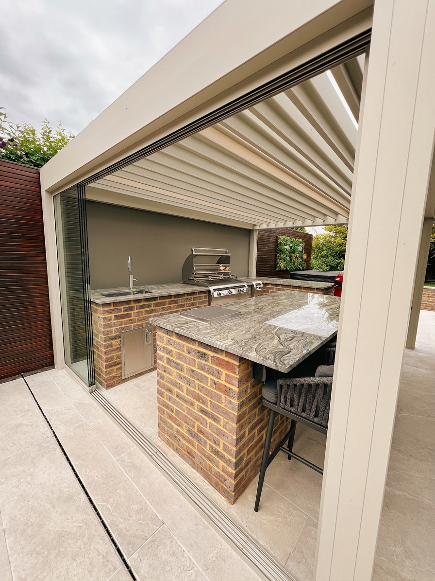 View through frameless glass screen into the outdoor kitchen and bar