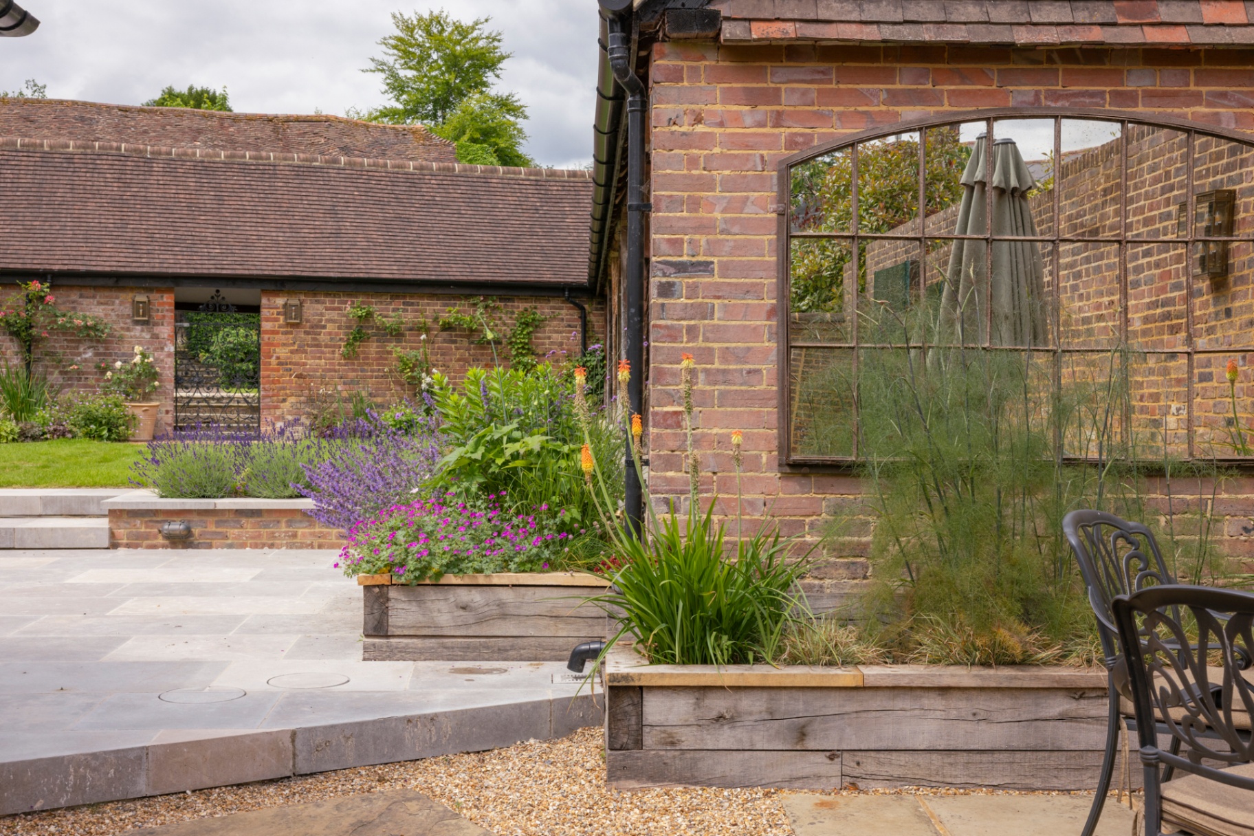 Raised oak sleeper beds with red-hot pokers and arched mirror