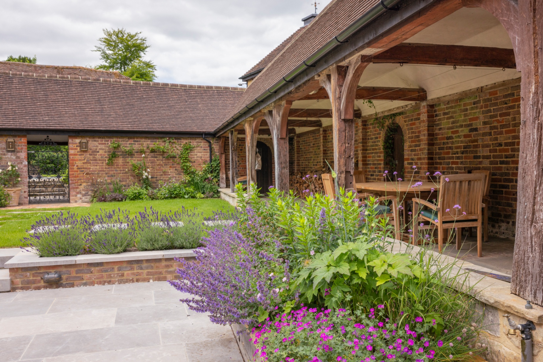 Oak-framed loggia with lavender beds and stone terrace