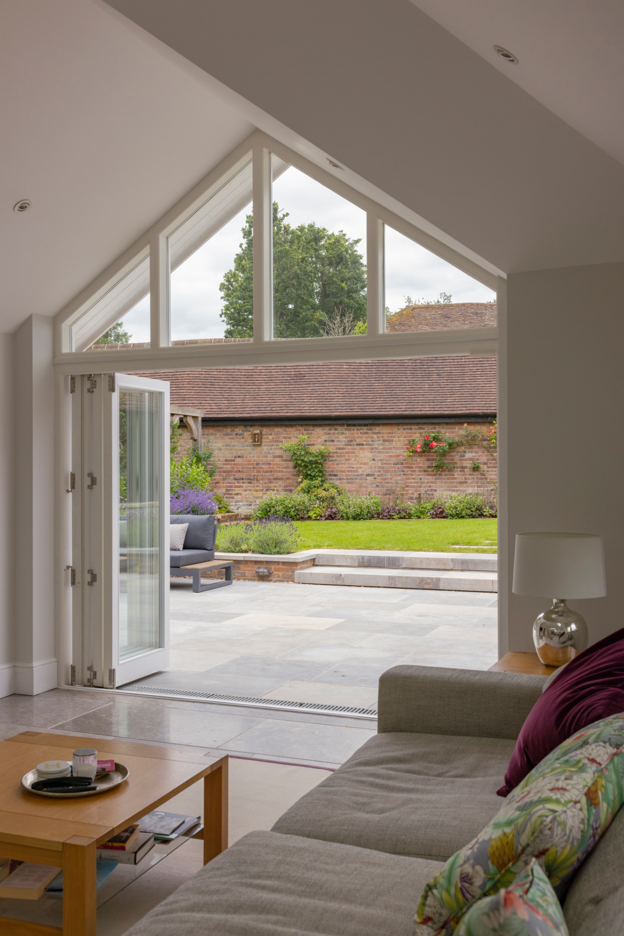 Bifold doors opening from living room onto the patio and lawn